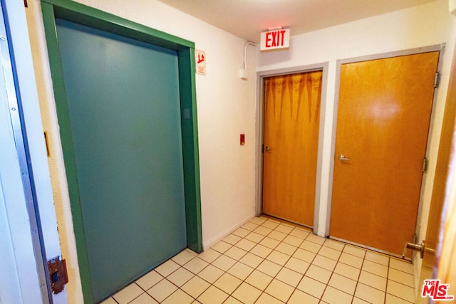 corridor with light tile patterned flooring