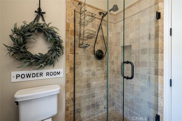 bathroom with toilet and a stall shower