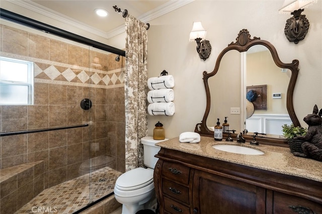 bathroom featuring ornamental molding, vanity, toilet, and a shower with door