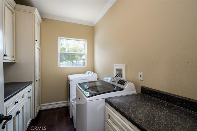 washroom with dark wood-type flooring, washing machine and dryer, cabinets, and ornamental molding