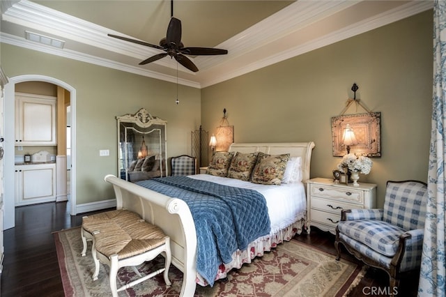 bedroom with ornamental molding, dark hardwood / wood-style flooring, and ceiling fan