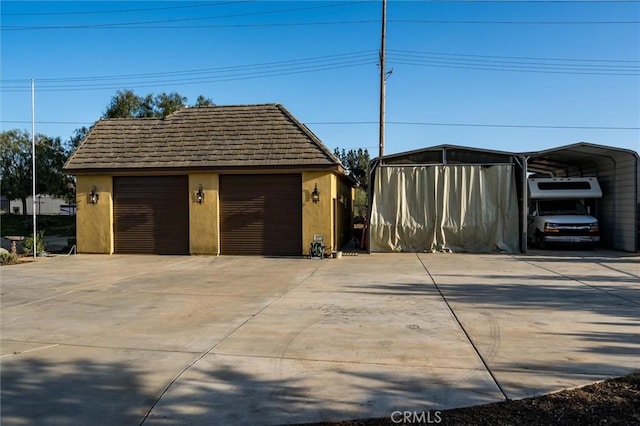 detached garage with a detached carport