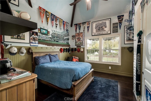 bedroom with wainscoting, vaulted ceiling, wood finished floors, and ceiling fan