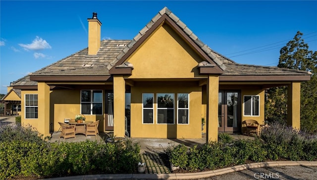 rear view of house featuring outdoor lounge area and a patio