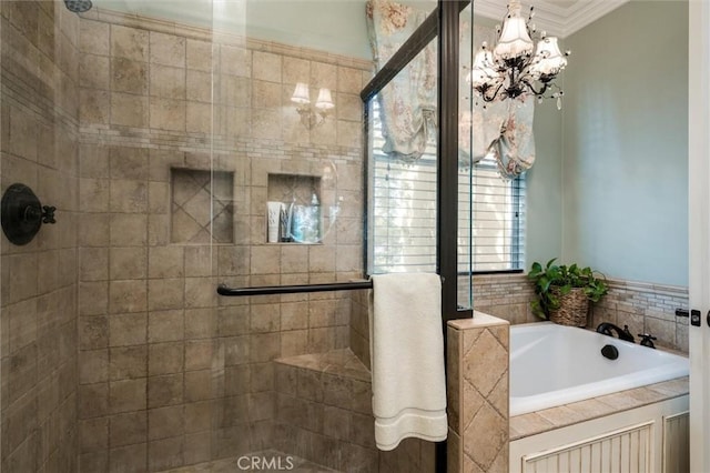 bathroom featuring a bath, a chandelier, ornamental molding, and a stall shower