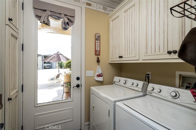 laundry room with cabinets and washing machine and dryer