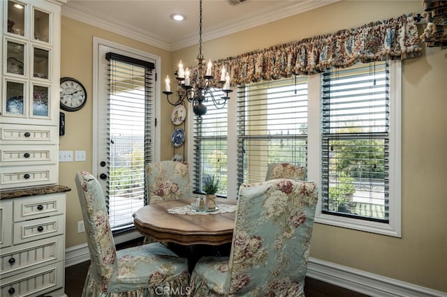 dining area featuring an inviting chandelier, crown molding, dark hardwood / wood-style flooring, and a healthy amount of sunlight