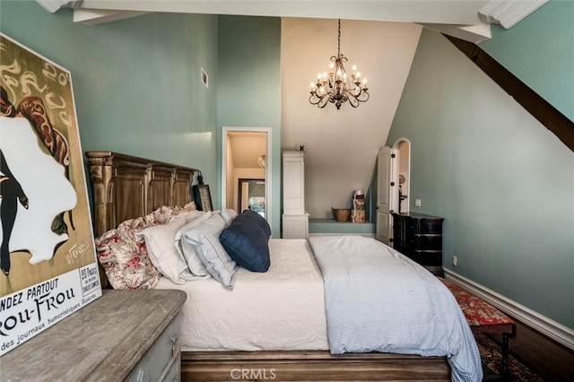 bedroom with lofted ceiling and a chandelier