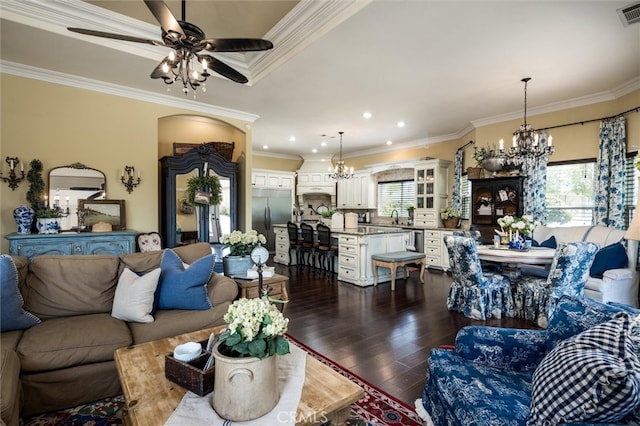 living room featuring ornamental molding, dark hardwood / wood-style flooring, and a wealth of natural light