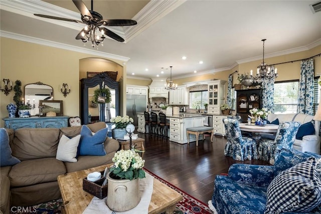 living area with crown molding, a wealth of natural light, and dark wood finished floors