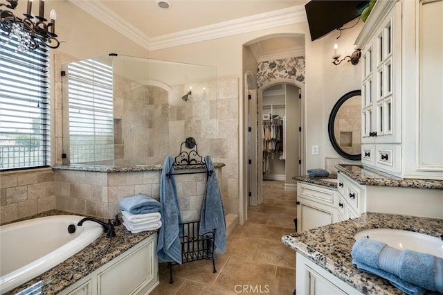 bathroom with ornamental molding, vanity, and shower with separate bathtub