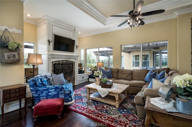 living room featuring ornamental molding, ceiling fan, and dark wood-type flooring