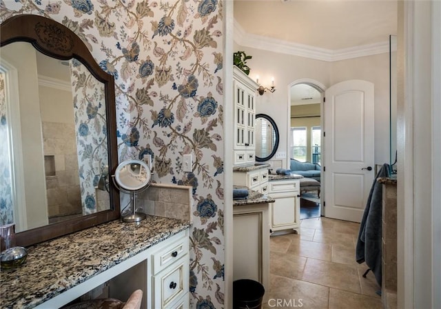 bathroom with tile patterned flooring, wallpapered walls, and crown molding