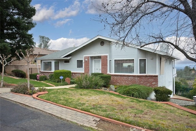 ranch-style home featuring a front yard