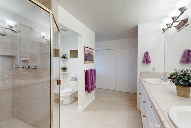 bathroom featuring toilet, an enclosed shower, and vanity