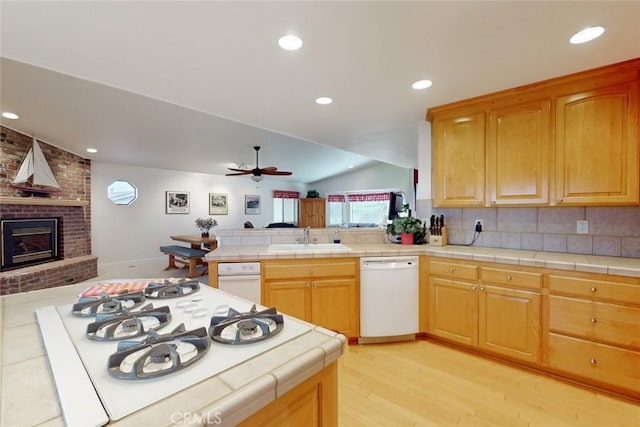 kitchen with sink, dishwasher, and tile countertops