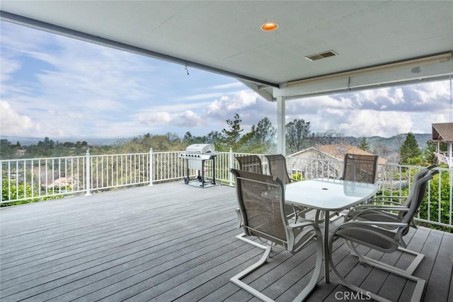 wooden deck featuring a mountain view and grilling area