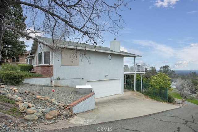 view of property exterior featuring a garage and a balcony