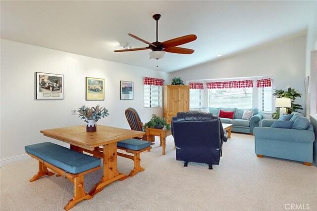 living room with ceiling fan, light carpet, and lofted ceiling