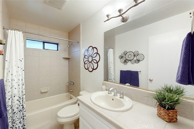 full bathroom featuring toilet, vanity, and shower / bath combo with shower curtain