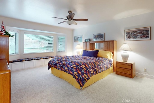 bedroom featuring light carpet and ceiling fan