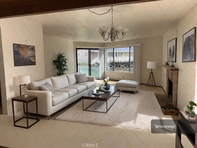 living area with a chandelier and a fireplace