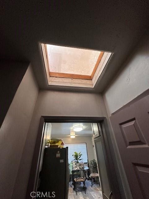 details featuring hardwood / wood-style floors and a skylight