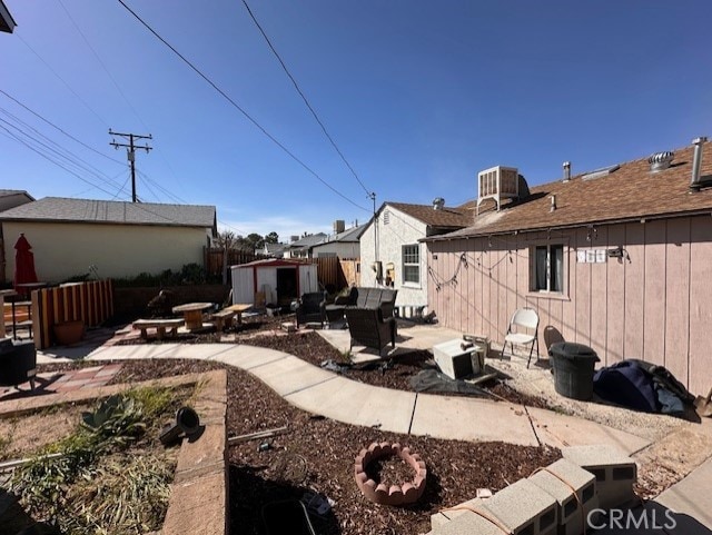 rear view of house with a patio and a shed