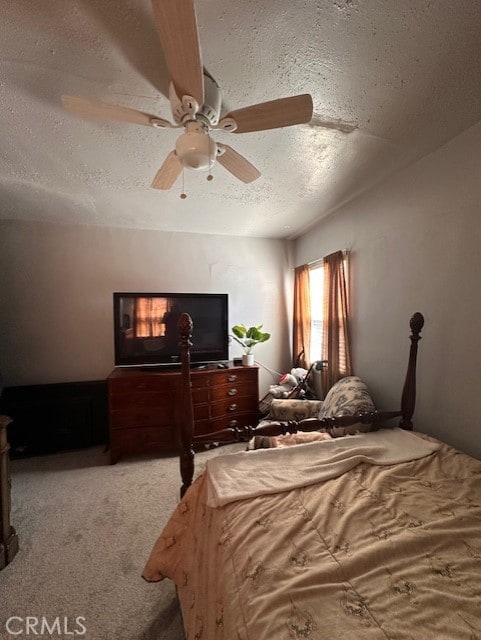 carpeted bedroom with ceiling fan and a textured ceiling