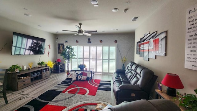 living room featuring ceiling fan and light wood-type flooring