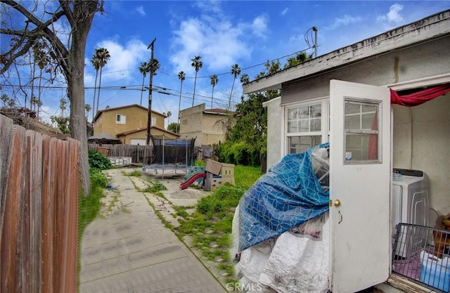 view of yard featuring washer / clothes dryer and a trampoline