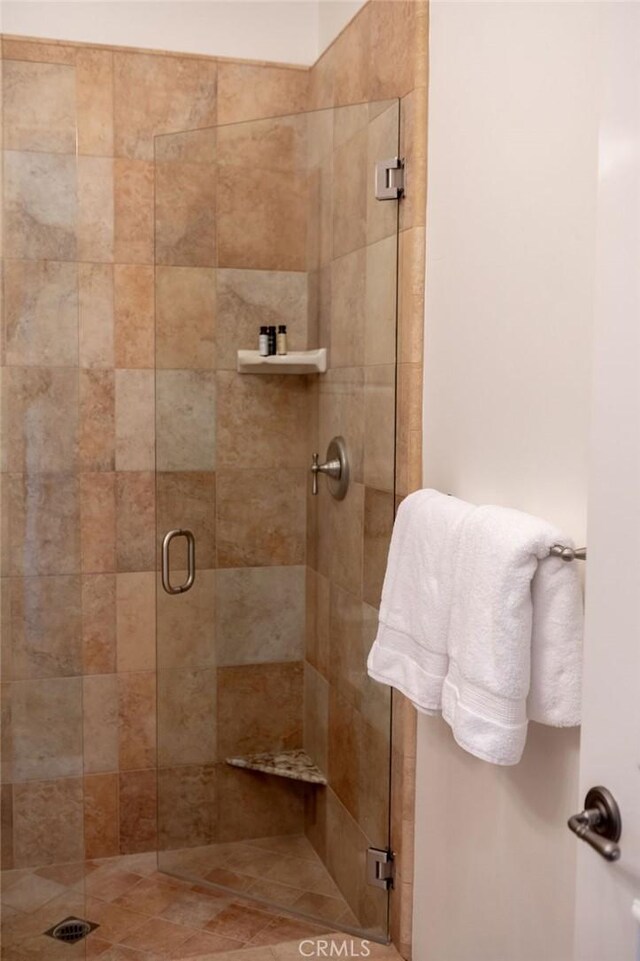 bathroom with a shower with door