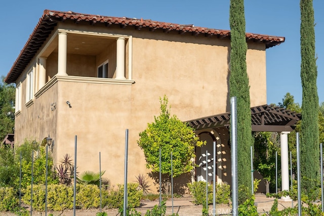 view of side of property with a pergola