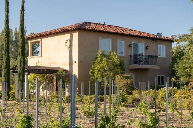 rear view of house featuring a balcony