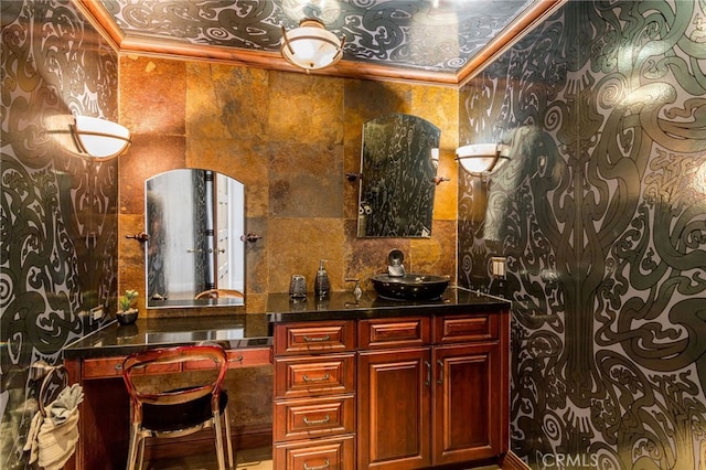 bar with dark stone countertops and crown molding