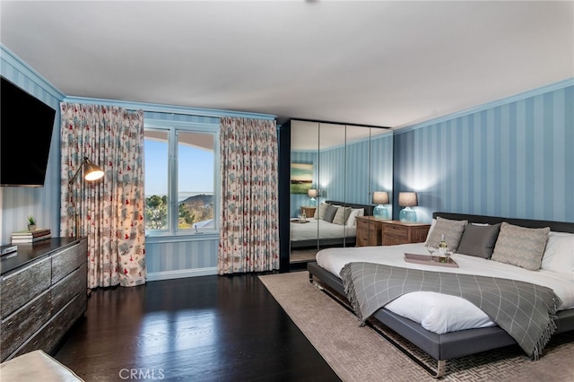 bedroom with dark hardwood / wood-style flooring