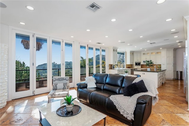 living room with a mountain view and sink