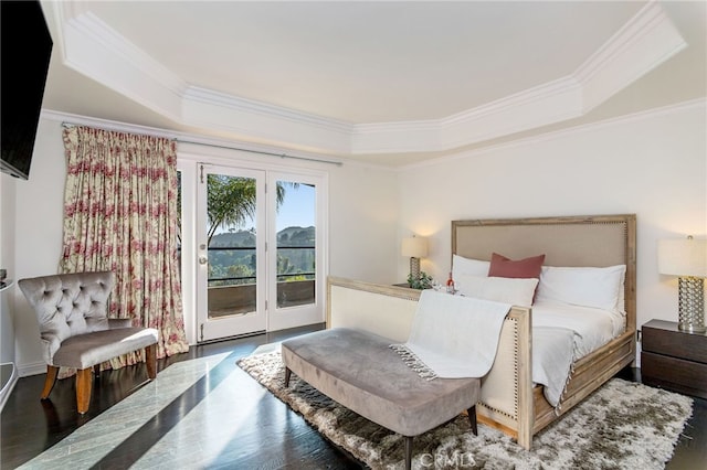 bedroom with wood-type flooring, ornamental molding, and access to exterior