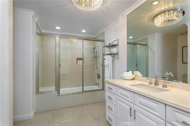 full bathroom with vanity, ornamental molding, bath / shower combo with glass door, tile patterned floors, and an inviting chandelier