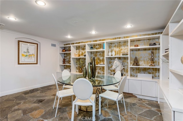 dining space with crown molding