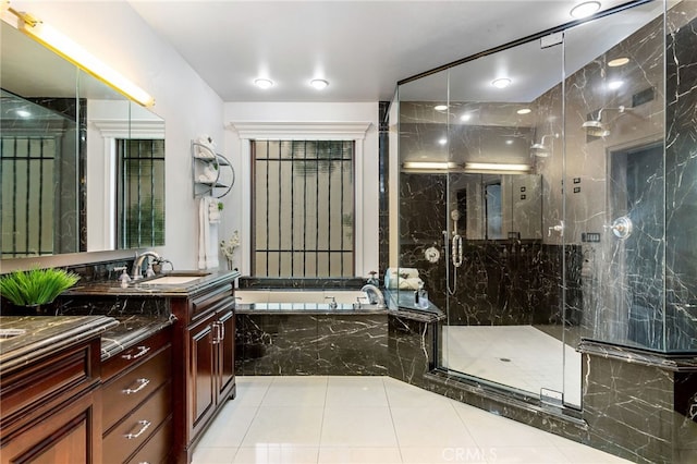 bathroom featuring shower with separate bathtub, tile patterned floors, and vanity