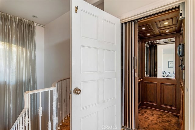 corridor with carpet flooring