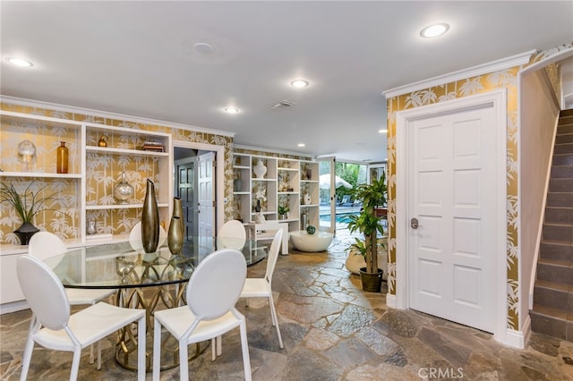 dining room featuring crown molding