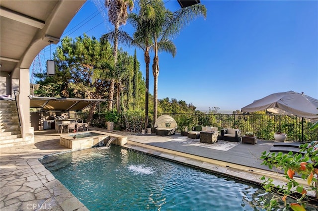 view of swimming pool with an outdoor living space, an in ground hot tub, and pool water feature