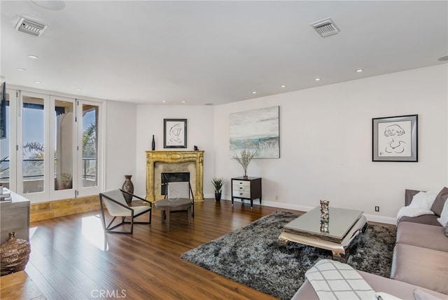 living room with french doors, hardwood / wood-style flooring, and a fireplace