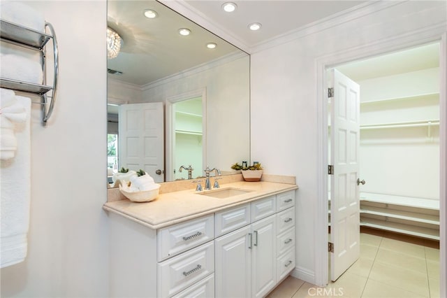 bathroom with ornamental molding, tile patterned flooring, and vanity