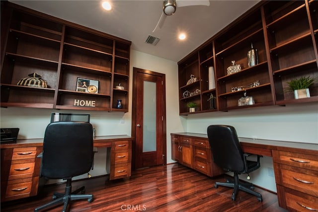 office featuring built in desk, ceiling fan, and dark hardwood / wood-style flooring