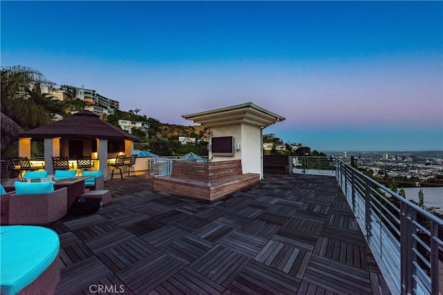 patio terrace at dusk featuring an outdoor hangout area and a gazebo