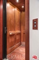 details with hardwood / wood-style floors and elevator