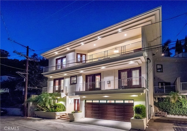 contemporary home with a balcony and a garage